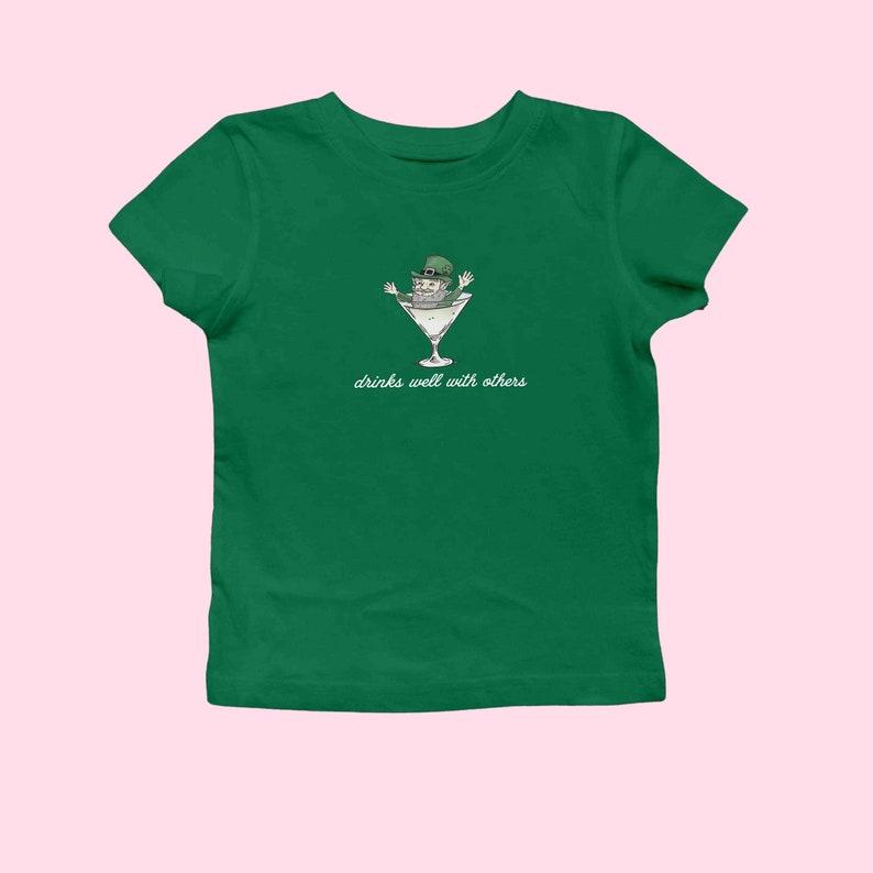 St. Patrick's Day Women's Baby Tee - Funny Leprechaun Martini Cocktail Shirt for Party Enthusiasts