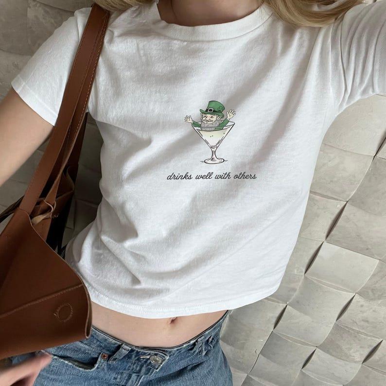 St. Patrick's Day Women's Baby Tee - Funny Leprechaun Martini Cocktail Shirt for Party Enthusiasts