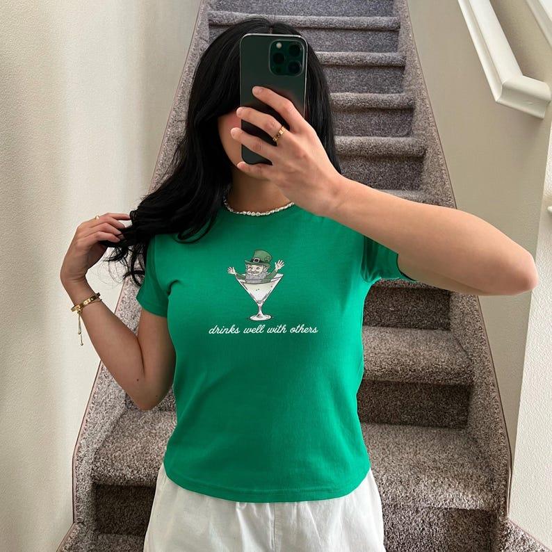 St. Patrick's Day Women's Baby Tee - Funny Leprechaun Martini Cocktail Shirt for Party Enthusiasts